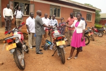 Chief Administrative Officer/Apac, Canon George Adoko hands over the key to Akech Caroline