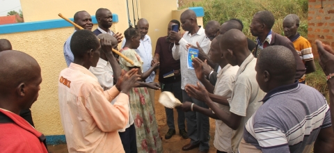 Assistant RDC Janol Okot handing over the Latrine keys to Chairperson Atek Central.